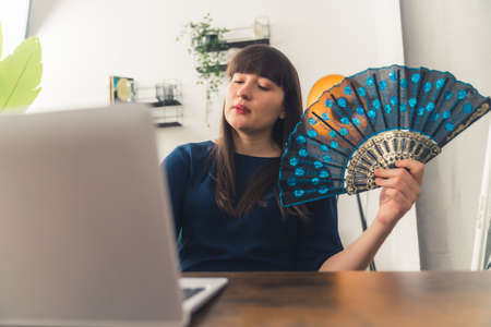 Young caucasian woman during video call with her friends showing them her new purchase, beautiful...