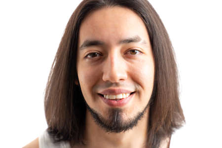 Studio portrait of a bearded long-haired caucasian man looking at camera and showing his toothy smile. Isolated over white background. High quality photoの写真素材