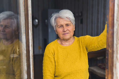 Portrait of an elderly Caucasian grandmother looking to the camera. High quality photo