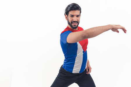 lets start dancing - bearded Latin American man in T-shirt of Cuban flag making dance element on white background studio shot isolated copy space cowboy shot. High quality photoの写真素材