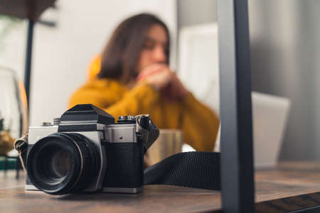 Attractive young male photographer working, focus on the camera in the foreground copy space . High quality photoの写真素材