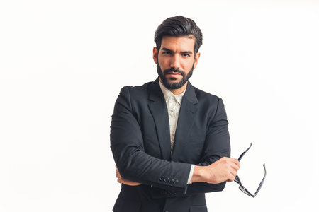 elegant Latino American man with flirty look holding sunglasses infinity white studio shot medium...