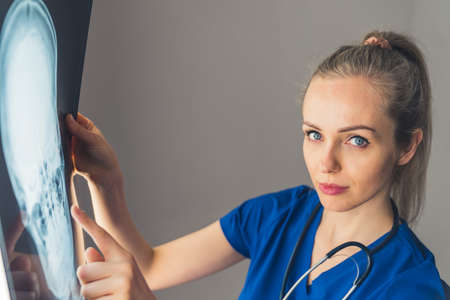 nurse with X-ray of patients head medical concept medium closeup indoors. High quality photo