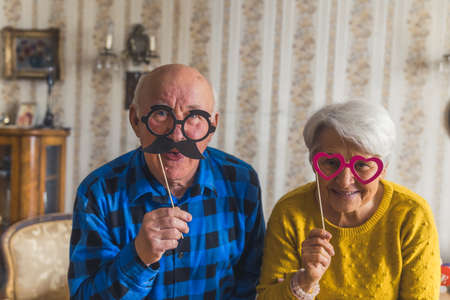 cheerful grandparents with cute glasses senior people support concept living room medium closeup ....
