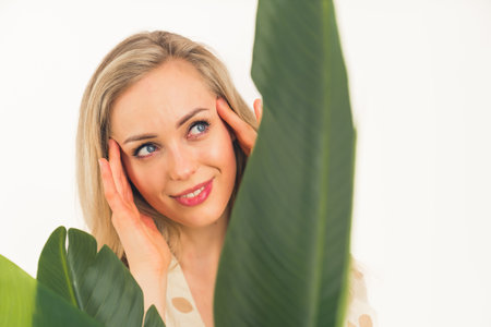 Spa, wellness, skincare. Beautiful caucasian woman in her 20s touching her smooth skin after a treatment. Advertisement concept. High quality photoの写真素材