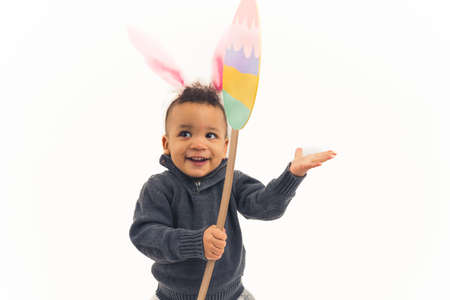 Easter break concept. Innocent curious cute biracial baby boy laughing while wearing furry bunny...