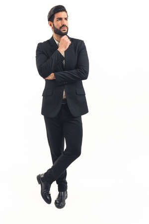 verical shot, handsome latin man pondering, full-length. High quality photoの写真素材