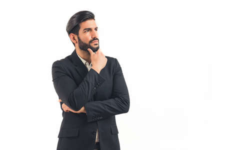 Handsome bearded young man holding his chin, guy wearing suit, isolated on white background. High...