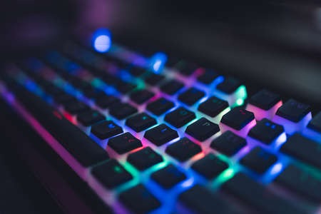 Colourful illuminated gamer keyboard with black push-bottoms. Red, green, blue, pink. High quality...