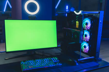 Mockup green screen desktop computer monitor in gamer cafe. Top-end professional equipment. High quality photoの写真素材