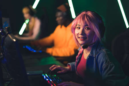 Young Asian female player looking at the camera copy space video games concept . High quality photoの写真素材