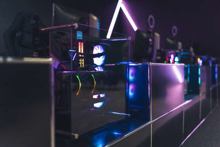 View from the back on colorful top-end system unit for gaming. Internet gamer cafe interior. High...