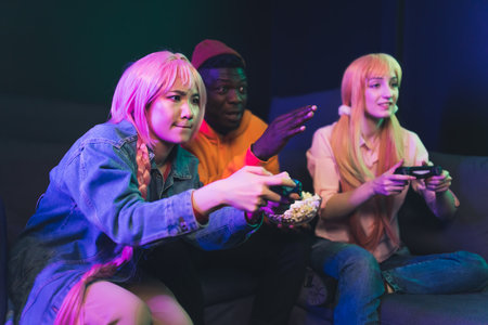 multi-ethnic hipsters play video games copy space dark background . High quality photo