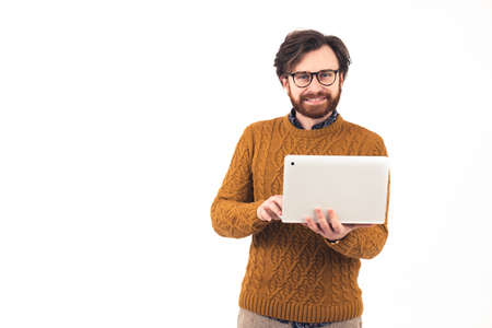 Satisfied good-looking joyful european man in his 30s wearing a patterned sweater holding a white...