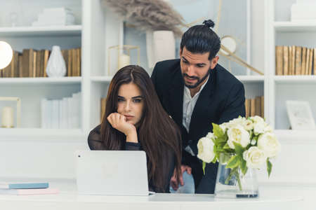 Handsome Latin man explaning details of work to a new employee at the office. High quality photoの写真素材