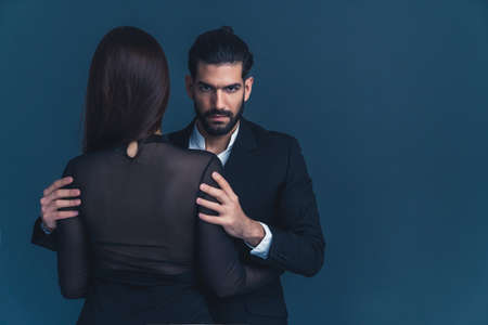 Couple Beauty Portrait, Beautiful Woman in black dress embracing Elegant Man, Love. High quality photoの写真素材