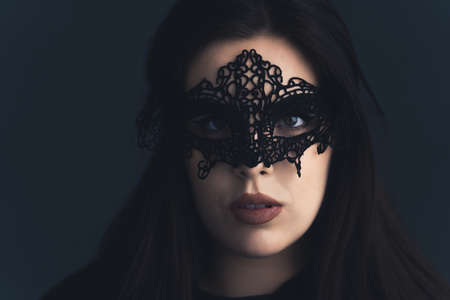 Closeup studio portrait of a beautiful sexy seductive dark-haired caucasian woman with wearing a mat...