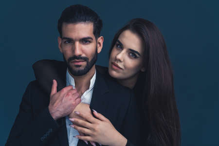 Portrait of young beautiful couple in love. Woman embracing handsome latin man . High quality photo