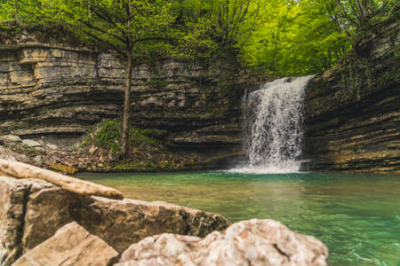 view of a small spectacular waterfall in the green forest. High quality photoの写真素材