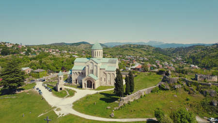 scenic drone shot of Cathedral of Dormition, temple of Georgian Orthodox Church in Kutaisi against the cityscape, Bagrati Cathedralの写真素材