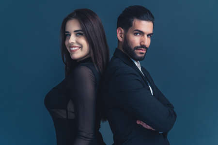 Equality at work. Young professional beautiful business couple looking at camera and being positive...