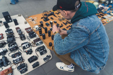 18.05.2022. Tbilisi, Georgia. customer browsing the retro cameras at the flea market. High quality photoのeditorial素材