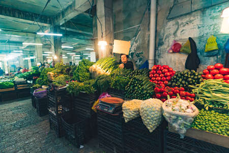 16.05.2022. Kutaisi, Georgia. senior woman selling vegetable in the local market, Kutaisi, Georgia. High quality photoのeditorial素材