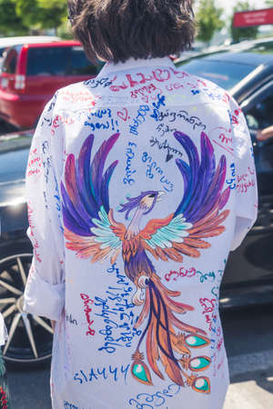 18.05.2022. Tbilisi, Georgia. boy wearing a white shirt with a painting and inscriptions on it on...