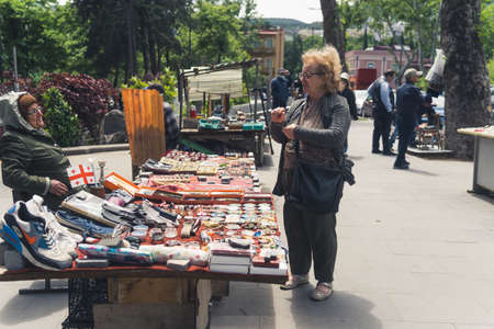 18.05.2022. Tbilisi, Georgia. a customer talking to a seller at the Flea market. High quality photo