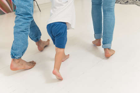 little boy walking with his parents in the kitchen family concept. High quality photoの写真素材
