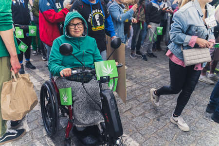 05.28.2022 Warsaw, Poland. Middle-aged caucasian woman with walking disability sitting on a wheelchair fighting for the right to legal marijuana. Relief in pain. High quality photoのeditorial素材