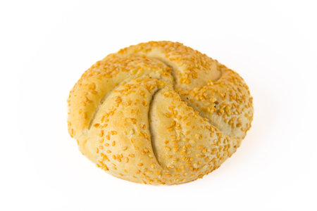 Variation of a traditional kaiser roll. Single round bread roll with toasted sesame seed topping...