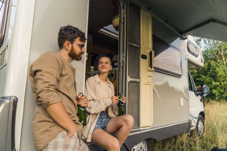 enjoyable road trip - Caucasian girl and boy talking near to the van. High quality photoの写真素材