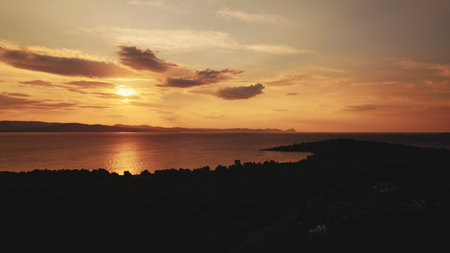 Seascape seen from island land perspective. Aerial view of stunning red, yellowish sunset. Few clouds up in the sky. High quality photoの写真素材