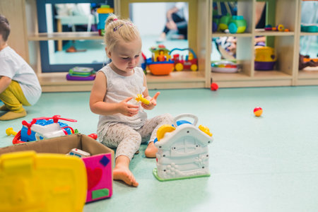 cute girl building a barbie house in the nursery. High quality photoの写真素材