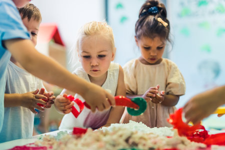 kids playing with kinetic sand at the nursery. High quality photoの写真素材