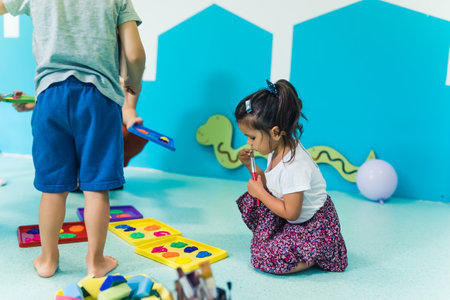 preschoolers playing with colors with their teacher in the kindergarten. High quality photoの写真素材