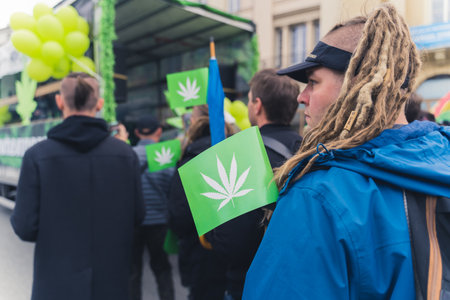 05.28.2022 Warsaw, Poland. European protester in dreadlocks holding green flag with white...