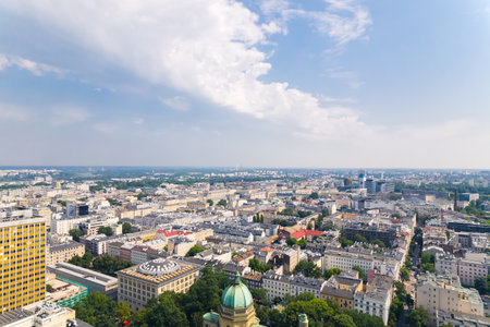 7.22.2022 Warsaw, Poland. European city cityscape. Mix between architectural styles and nature. Drone aerial perspective. Blue sky with fluffy white clouds. High quality photoのeditorial素材