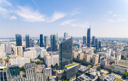 7.22.2022 Warsaw, Poland. Eclectic developing city. Neomodernism as a skyline architecture. Aerial drone shot, blue sky, sunny weather. High quality photoのeditorial素材