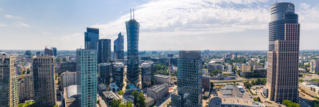 7.22.2022 Warsaw, Poland. Wide panoramic shot from birds eye perspective showing Warsaw Trade Tower, Warsaw Spire, and other known skyscrapers. Life in the city concept. High quality photoのeditorial素材