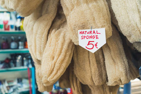 Natural sponges for sale in a greek local Kapani Market. Sustainable product for sensitive skin and synthetic-free showering. High quality photoの写真素材
