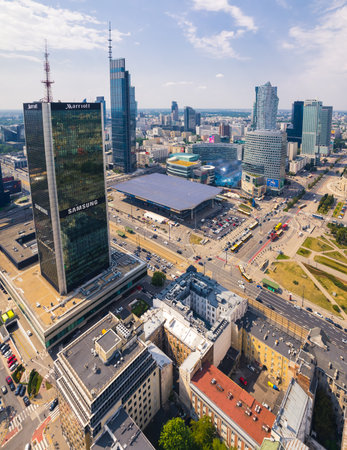 7.22.2022 Warsaw, Poland. Vertical drone perspective shot of downtown Warsaw. Centrum LIM skyscraper and Central Railway Station. High quality photoのeditorial素材