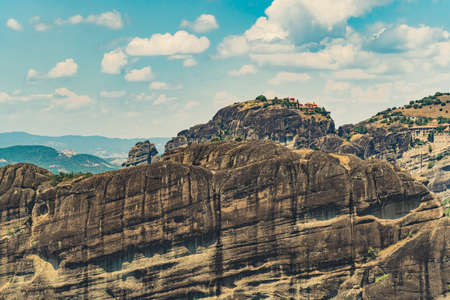 Rock formations of Meteora, Greece. Summer holidays concept. Aerial shot of the summits. Blue sky, fluffy white mountains. High quality photoの写真素材