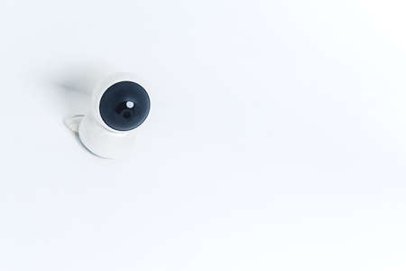 Isolated modern surveillance IP camera on a white wall. High quality photoの写真素材