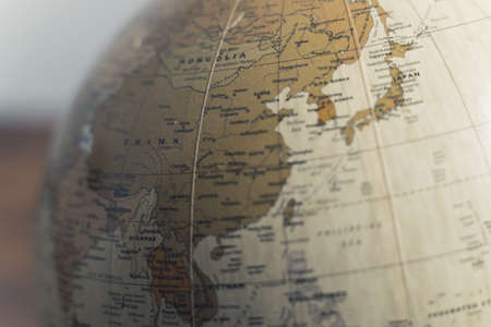Close up of Mongolia, China and India on a spinning geographical physical globe. Earth model on a...