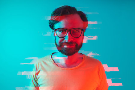 Glitch effect used on closeup studio shot of a 30-year-old caucasian bearded man in big glasses and...