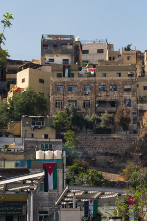 06.18.2022. Amman, Jordan. old buildings and houses with the flag of Jordan on them. High quality photoのeditorial素材