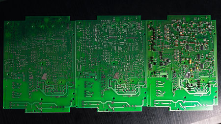 Green Printed Circuit Board (PCB) with some Surface Mount Device (SMD) components and chips. High...