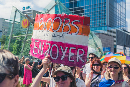 June 25, 2022 Warsaw, Poland - Equality parade in Warsaw, Poland. Girls holding a funny and supportive protest sign in support of the LGBTQ community. High quality photoのeditorial素材